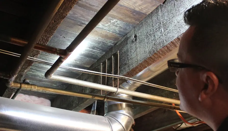 Mastertech of Orange County technician performing moisture mapping with a meter and thermal camera during a mold inspection in Orange County, CA.